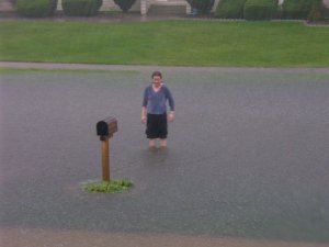 NinjaBitch stands in the knee deep water flooding her street.